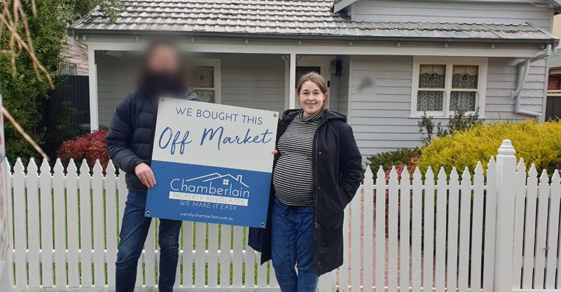 Courtney standing in front of her newly purchased first home, with the help of Wendy Chamberlain, Buyer's Advocate of Chamberlain Property Advocates.