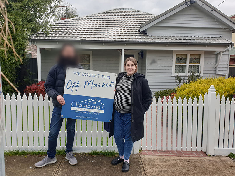 Courtney standing in front of her newly purchased first home, with the help of Wendy Chamberlain, Buyer's Advocate of Chamberlain Property Advocates.