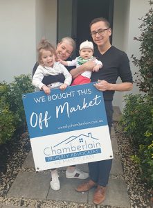 Young happy couple with two young children who have just bought their property off market with Chamberlain Property Advocates.