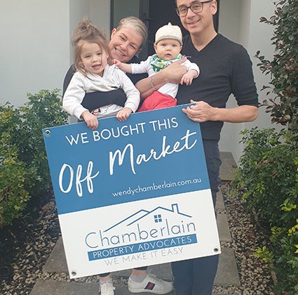 Young happy couple with two young children who have just bought their property off market with Chamberlain Property Advocates.